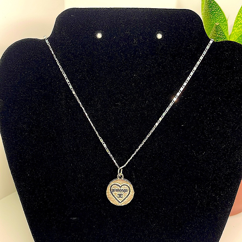 Repurposed designer zipper pull tag